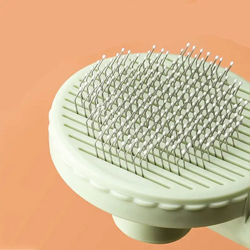 Peigne à chat - Design ergonomique pour Poils Morts, brosse blanche avec manche blanc sur fond rose